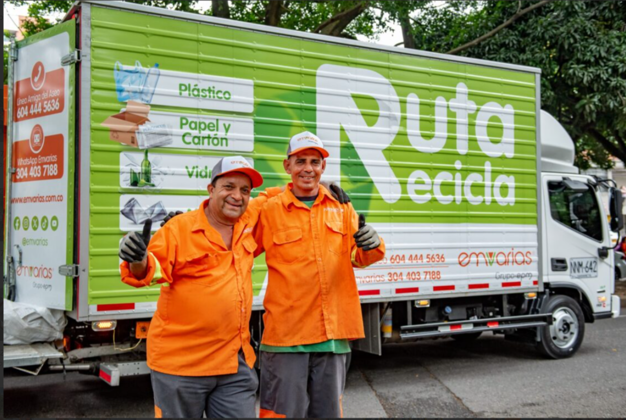 Dos personas de Emvarias junto con un camión de basuras.